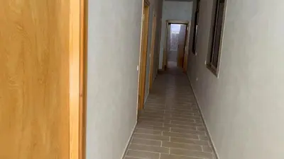 a hallway with a tile floor in a room at Ferme a Ain Tizgha Benslimane in O Ben Slimane