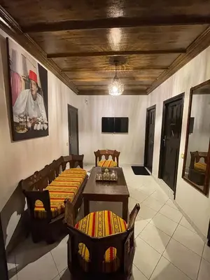 a living room with a couch and a table and chairs at Suite des lumières Al Malaki Offre Spéciale front Mer, Zéro Surprise- l'Accueil Aéroport & Service Cuisine si besoin de Tranquillité Totale in Rabat
