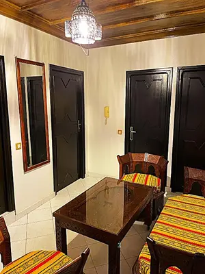 a dining room with a table and chairs and a chandelier at Suite des lumières Al Malaki Offre Spéciale front Mer, Zéro Surprise- l'Accueil Aéroport & Service Cuisine si besoin de Tranquillité Totale in Rabat
