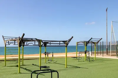 a group of empty benches in front of the beach at Suite des lumières Al Malaki Offre Spéciale front Mer, Zéro Surprise- l'Accueil Aéroport & Service Cuisine si besoin de Tranquillité Totale in Rabat