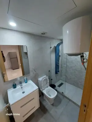 a bathroom with a toilet and a sink and a shower at Résidence Sheren in Casablanca