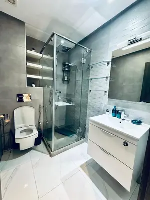 a bathroom with a shower and a toilet and a sink at Résidence Sheren in Casablanca