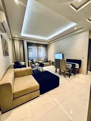 a living room with a couch and a table and a piano at Résidence Sheren in Casablanca