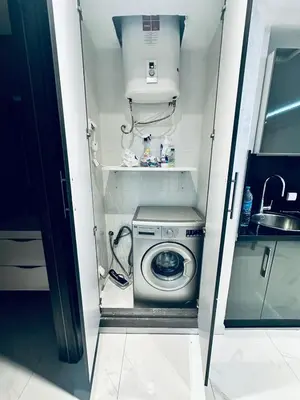 a washer and dryer in a small kitchen at Résidence Sheren in Casablanca