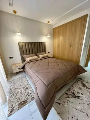 a bedroom with a large bed with a large blanket at Résidence sheren in Casablanca
