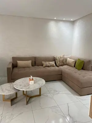 a living room with a couch and a table at Résidence Sheren in Casablanca