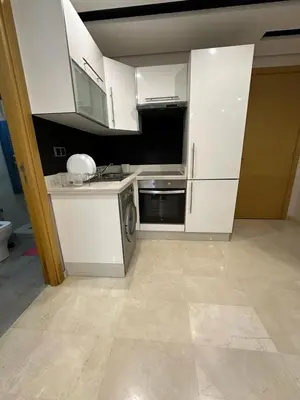 a kitchen with white cabinets and a dishwasher at Res in Casablanca