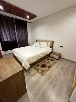 a bedroom with a bed and a large window at Res in Casablanca