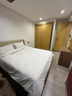 a bedroom with a large white bed in it at Res in Casablanca