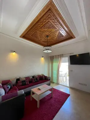 a living room with a couch and a table at Al Kawtar in Mansouria