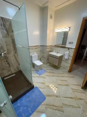 a bathroom with a shower and a toilet and a sink at Al Kawtar in Mansouria
