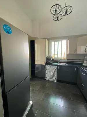 a kitchen with a refrigerator at Al Kawtar in Mansouria