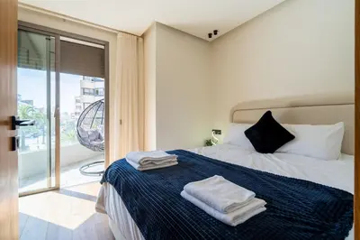 a bedroom with a bed with towels on it at Luxurious studio with view gym parking and keyless access in Casablanca