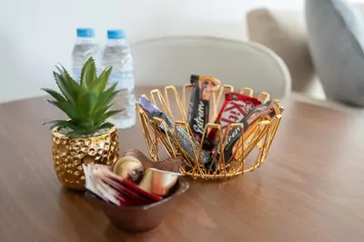 a wooden table with a basket of candy and a plant at Luxurious studio with view gym parking and keyless access in Casablanca