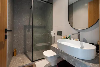 a bathroom with a sink and a glass shower at Luxurious studio with view gym parking and keyless access in Casablanca