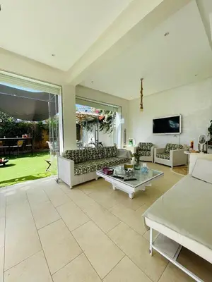 a large living room with couches and a tv at Villa with rooftop bar overlooking sea, pool & vegetable garden in Tamaris