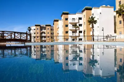 a pool of water in front of some buildings at residence al kawtar in Mansouria