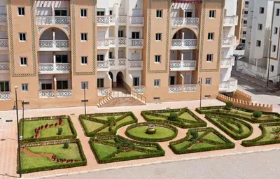 a large building with a garden in front of it at residence al kawtar in Mansouria