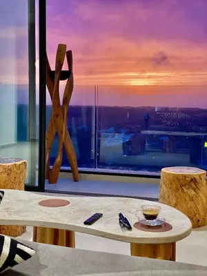 a table and chairs in front of a large window at Unique apartment in Prestigia Hay Riad Rabat in Rabat