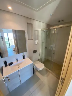 a bathroom with a sink and a toilet and a shower at Unique apartment in Prestigia Hay Riad Rabat in Rabat
