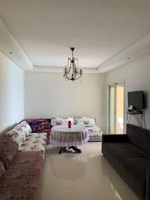 a living room with a couch and a table at ola blanca in Casablanca