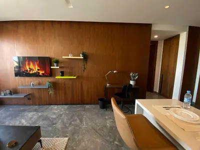a living room with a fire on the wall at Central Luxury Apartment with Fast Fiber WiFi, Panoramic Balcony & Free Parking in Casablanca CFC Casa Finnance City in Casablanca