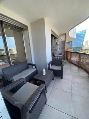 a balcony with couches and tables on a building at Central Luxury Apartment with Fast Fiber WiFi, Panoramic Balcony & Free Parking in Casablanca CFC Casa Finnance City in Casablanca