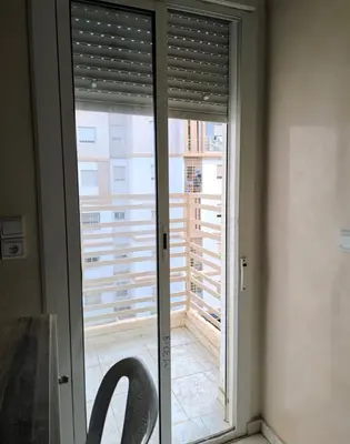 a sliding glass door with a view of a balcony at apartment a casablanca in Dar Ben Abdallah Ben Dehbi