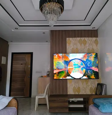 a living room with a flat screen tv on a wall at apartment a casablanca in Dar Ben Abdallah Ben Dehbi