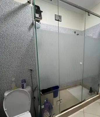 a bathroom with a toilet and a glass shower at Chic, quiet and convenient apartment in Casablanca