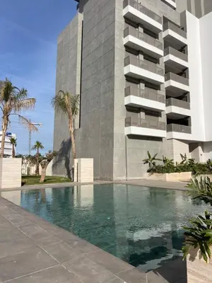 a swimming pool in front of a building at Appartement Casa finance city Studio Haut standing in Casablanca