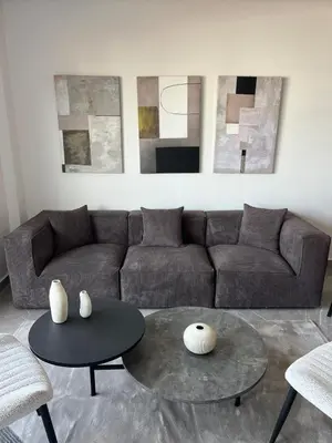 a living room with a couch and a table at Appartement Casa finance city Studio Haut standing in Casablanca