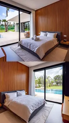 a bedroom with a large bed and a large window at Villa l'Hermitage in Oulad Mbark