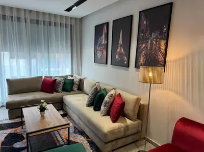 a living room with a couch and a table at Studio Chic Princesses Maarif - Wifi haut débit in Casablanca