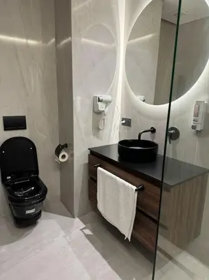 a bathroom with a sink and a toilet and a mirror at Studio Chic Princesses Maarif - Wifi haut débit in Casablanca