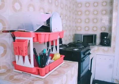 a toy kitchen with a red container with utensils at Comfortable Room 2 at Homestay Casablanca in Maarif