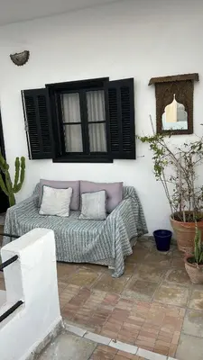 a couch sitting in the corner of a patio at Dar DIESUS NOOR in Azemmour