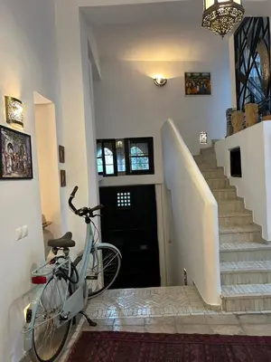 a bike parked in a hallway with a staircase at Dar DIESUS NOOR in Azemmour