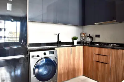a kitchen with a washing machine and a sink at Myhiven Immob in Casablanca
