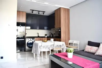 a kitchen and living room with a table and a couch at Myhiven Immob in Casablanca