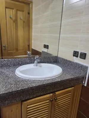 a bathroom counter with a sink and a mirror at Appartement à Casablanca in Casablanca