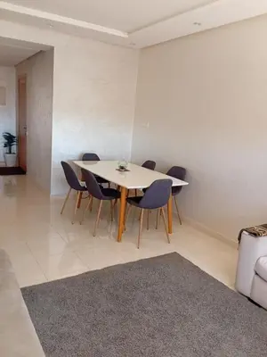 a dining room with a table and chairs at Appartement Jad & Rim in Bouznika