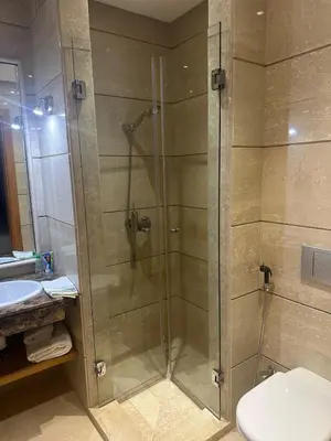 a bathroom with a shower with a toilet and a sink at Bouznika Bay Villa Prestigious Oasis in Sidi el Haj Bou Derbala