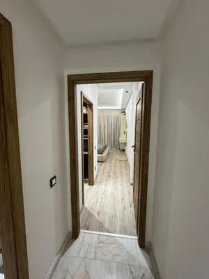 a hallway with an open door to a room at Appartement VictoriaBouskoura in Casablanca