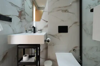 a white bathroom with a sink and a toilet at Modern & bright studio Balcony & Parking Maarif in Casablanca