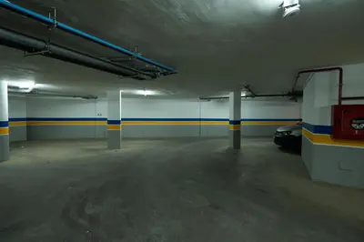 an empty parking garage with a car parked in it at Modern & bright studio Balcony & Parking Maarif in Casablanca