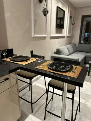 a kitchen with a table with two wine glasses on it at Maarif in Casablanca