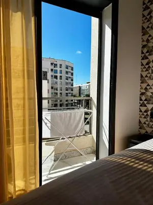 a bedroom with a window with a view of a city at Maarif in Casablanca