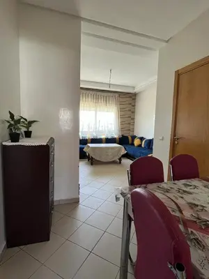 a living room with a couch and a table and chairs at Mansoria in Mansouria