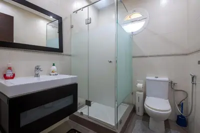 a bathroom with a shower and a toilet and a sink at Superb Villa in Bouznika with Private Pool & Hammam in Bouznika